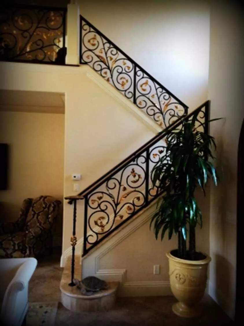 black and gold bannister with potted plant